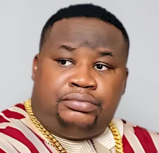 Cubana Chief Priest in a serious pose wearing a patterned shirt and gold chains, symbolizing his statement on naira spraying and EFCC crackdown.